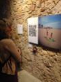 photo of person listening to the Pin-Up Girls audio QRt during an exhibit